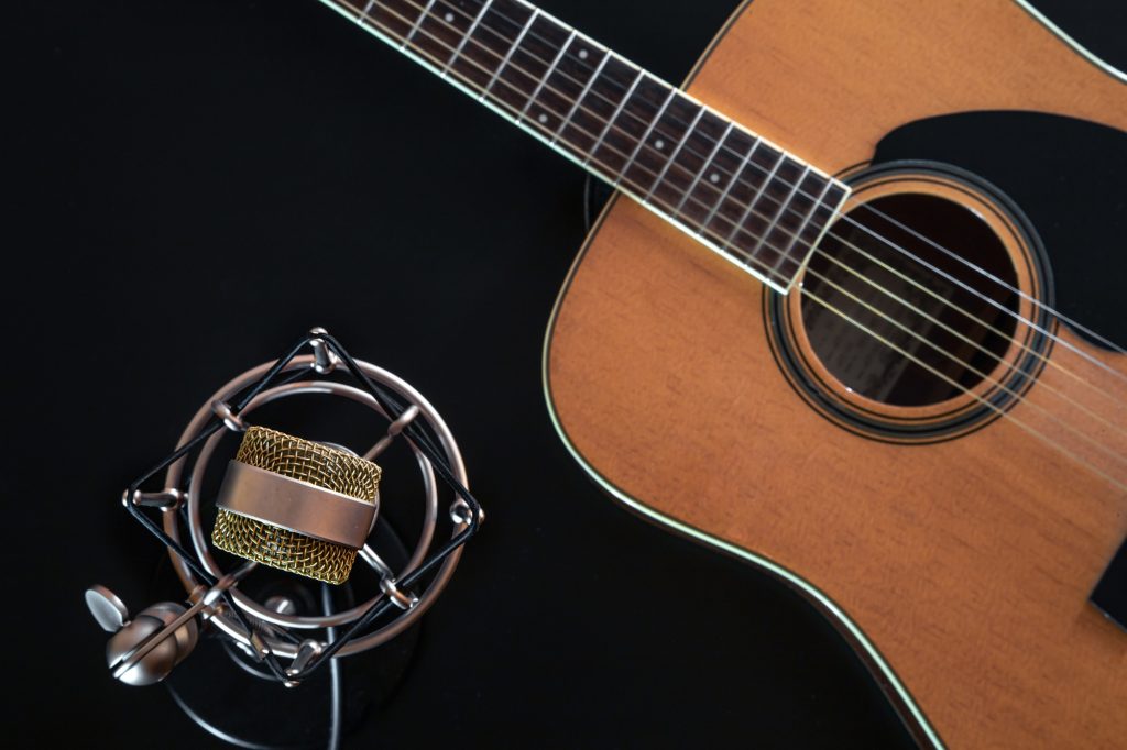 Flat lay, music background with acoustic guitar.